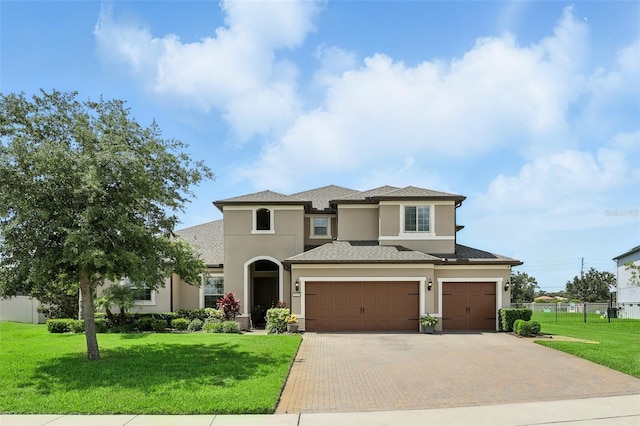 2118 Whiting Trl, Orlando, FL 32820 - view of front of house with stucco siding, decorative driveway, an attached garage, and a garage