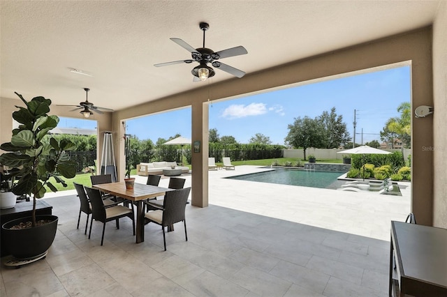 2118 Whiting Trl, Orlando, FL 32820 - fenced backyard featuring a ceiling fan, outdoor dining area, and a patio