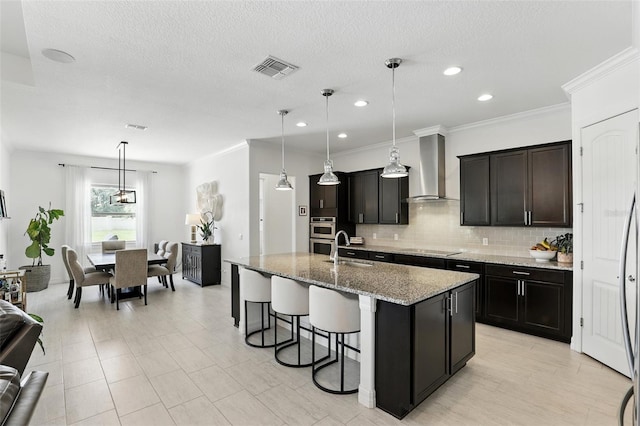 2118 Whiting Trl, Orlando, FL 32820 - kitchen with wall chimney exhaust hood, black electric cooktop, a breakfast bar, tasteful backsplash, and light stone counters
