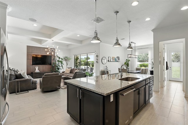 2118 Whiting Trl, Orlando, FL 32820 - kitchen with stainless steel dishwasher, decorative light fixtures, a chandelier, an island with sink, and light stone countertops