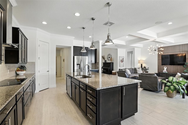 2118 Whiting Trl, Orlando, FL 32820 - kitchen with black electric cooktop, stainless steel fridge with ice dispenser, dark cabinets, wall chimney range hood, and light stone counters