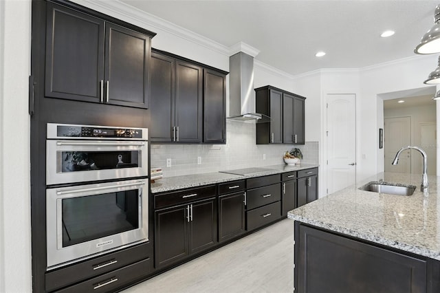 2118 Whiting Trl, Orlando, FL 32820 - kitchen with wall chimney range hood, stainless steel double oven, crown molding, light stone counters, and tasteful backsplash