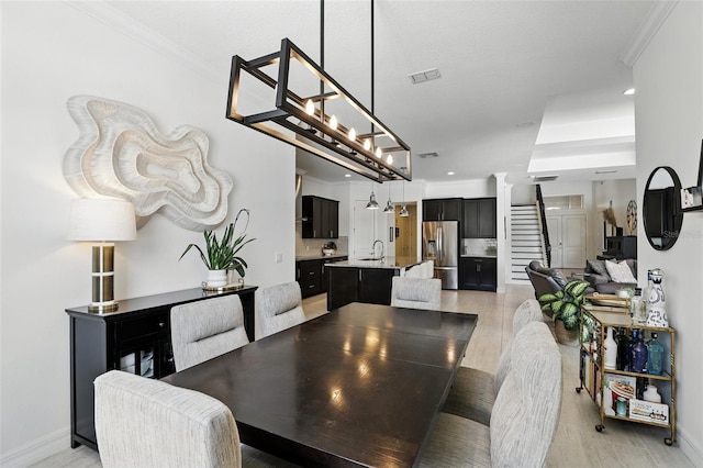 2118 Whiting Trl, Orlando, FL 32820 - dining room featuring light wood-style floors, ornate columns, crown molding, and recessed lighting