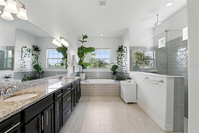 2118 Whiting Trl, Orlando, FL 32820 - bathroom featuring a garden tub, double vanity, a walk in shower, and recessed lighting