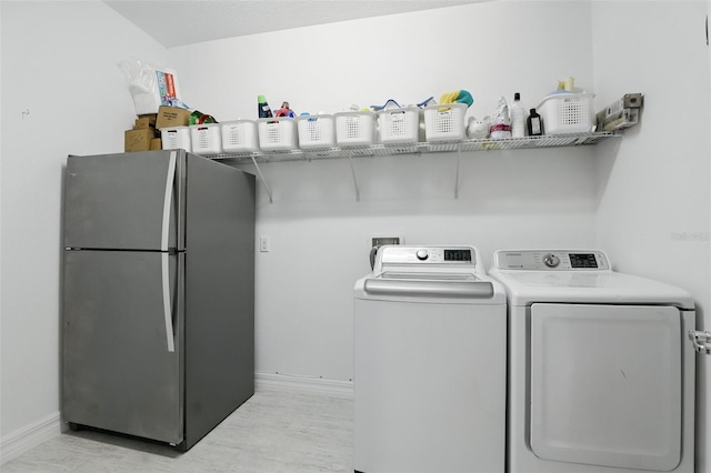 2118 Whiting Trl, Orlando, FL 32820 - laundry room with washer and dryer and light wood-style flooring