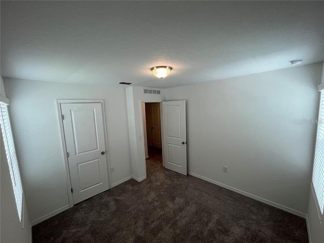 477 Madison Dr, Davenport, FL 33837 - unfurnished bedroom featuring carpet and baseboards