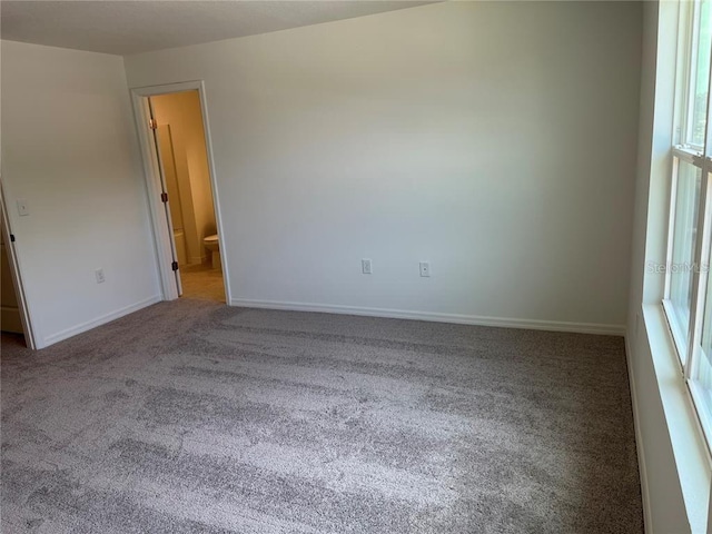 477 Madison Dr, Davenport, FL 33837 - spare room featuring carpet, plenty of natural light, and baseboards