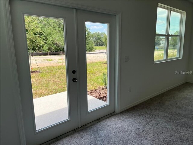 477 Madison Dr, Davenport, FL 33837 - doorway to outside with carpet floors, french doors, and baseboards