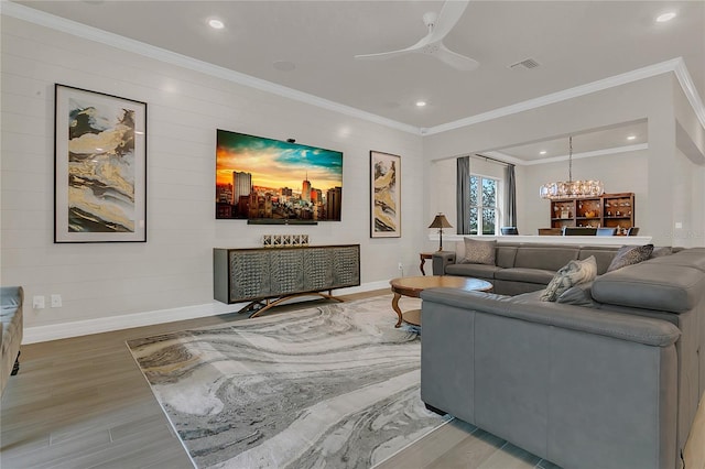 1938 Filly Trl, Oviedo, FL 32765 - living area featuring light wood-style flooring, crown molding, recessed lighting, a ceiling fan, and a chandelier