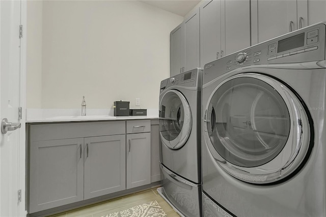 1938 Filly Trl, Oviedo, FL 32765 - washroom with cabinet space, washing machine and clothes dryer, and light wood finished floors
