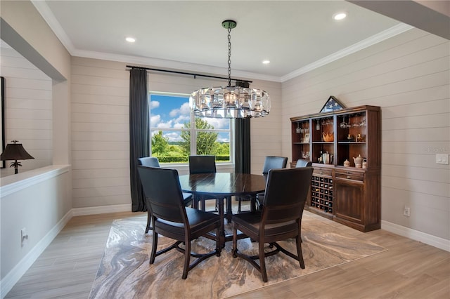 1938 Filly Trl, Oviedo, FL 32765 - dining room with a chandelier, crown molding, light wood-style floors, wooden walls, and recessed lighting