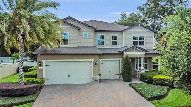 1938 Filly Trl, Oviedo, FL 32765 - craftsman-style home featuring a garage, decorative driveway, roof with shingles, and stucco siding