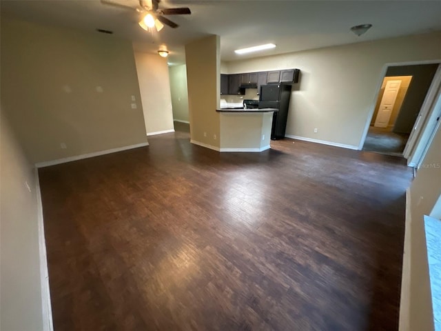 3805 N Cranberry Blvd, North Port, FL 34286 - unfurnished living room featuring a ceiling fan and dark wood-style floors