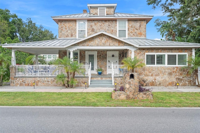 6501 Matchett Rd, Belle Isle, FL 32809 - traditional style home with a standing seam roof, stone siding, a porch, and a metal roof