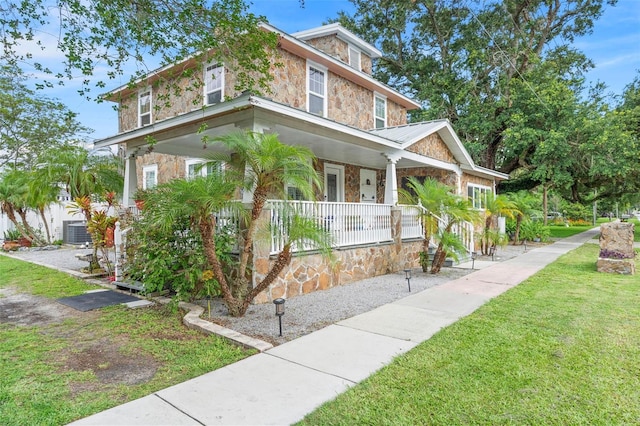 6501 Matchett Rd, Belle Isle, FL 32809 - view of front of home with covered porch, stone siding, and a front lawn