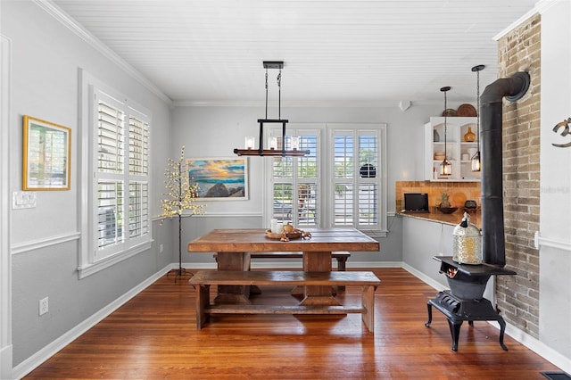 6501 Matchett Rd, Belle Isle, FL 32809 - dining room with a wood stove, wood finished floors, and ornamental molding