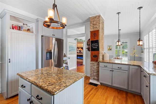6501 Matchett Rd, Belle Isle, FL 32809 - kitchen with stainless steel fridge with ice dispenser, gray cabinets, light wood-style flooring, a center island, and crown molding