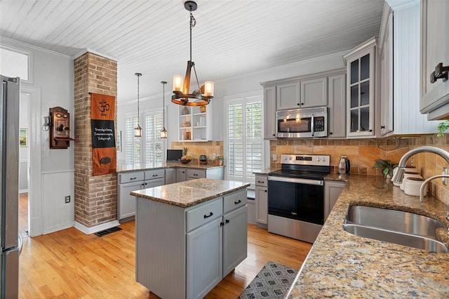 6501 Matchett Rd, Belle Isle, FL 32809 - kitchen with appliances with stainless steel finishes, gray cabinets, a chandelier, crown molding, and a kitchen island