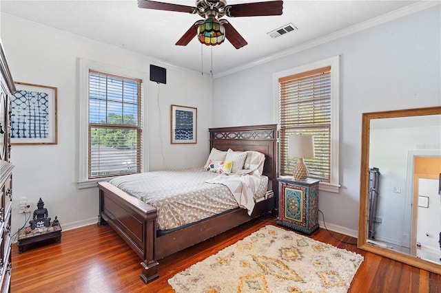6501 Matchett Rd, Belle Isle, FL 32809 - bedroom with multiple windows, wood finished floors, crown molding, and a ceiling fan
