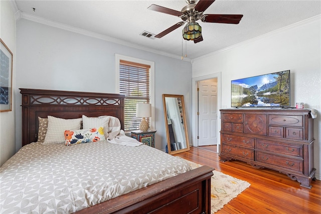 6501 Matchett Rd, Belle Isle, FL 32809 - bedroom with wood finished floors, crown molding, and a ceiling fan