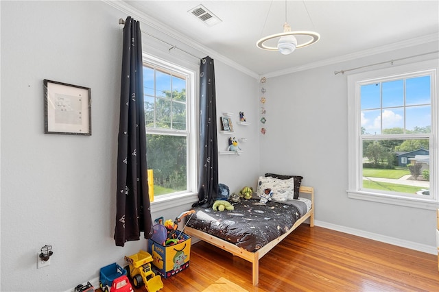 6501 Matchett Rd, Belle Isle, FL 32809 - bedroom with wood finished floors and crown molding