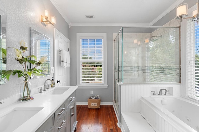 6501 Matchett Rd, Belle Isle, FL 32809 - bathroom featuring a tub with jets, hardwood / wood-style flooring, double vanity, a shower stall, and crown molding