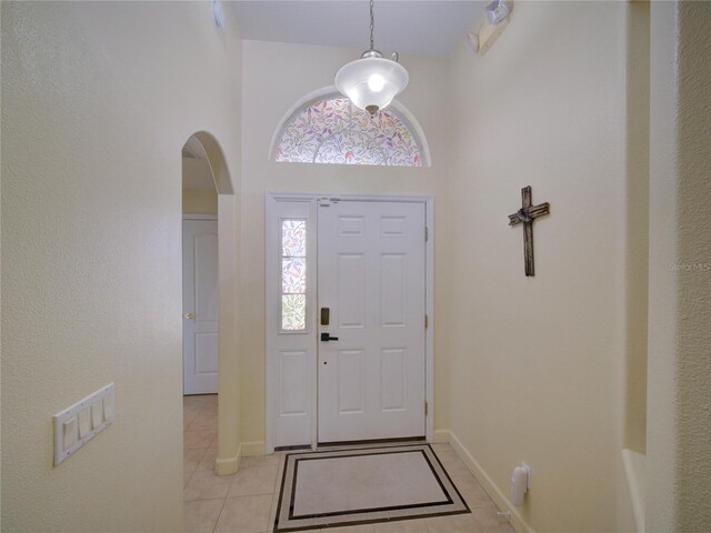 456 Old Bridge Cir, Davenport, FL 33897 - foyer with light tile patterned flooring, arched walkways, and a high ceiling