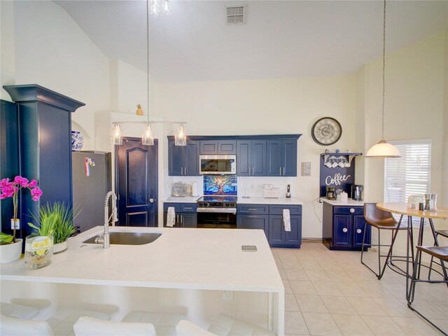 456 Old Bridge Cir, Davenport, FL 33897 - kitchen featuring stainless steel appliances, high vaulted ceiling, blue cabinets, light countertops, and a peninsula
