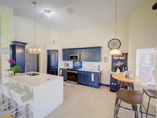 456 Old Bridge Cir, Davenport, FL 33897 - kitchen with high vaulted ceiling, stainless steel appliances, blue cabinetry, light countertops, and a kitchen bar