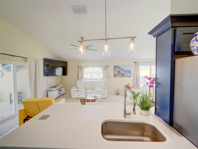 456 Old Bridge Cir, Davenport, FL 33897 - kitchen with freestanding refrigerator, vaulted ceiling, a ceiling fan, light countertops, and hanging light fixtures
