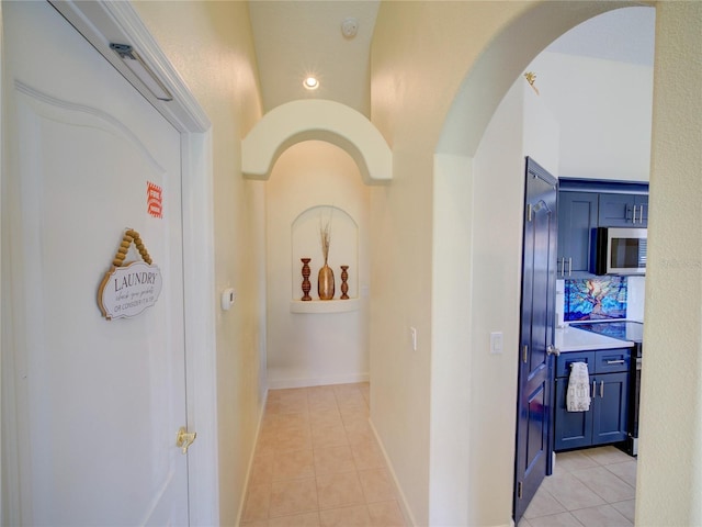 456 Old Bridge Cir, Davenport, FL 33897 - hallway with arched walkways, light tile patterned flooring, and recessed lighting