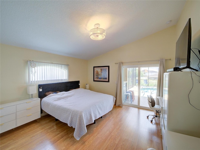 456 Old Bridge Cir, Davenport, FL 33897 - bedroom with lofted ceiling, access to outside, and light wood-style floors