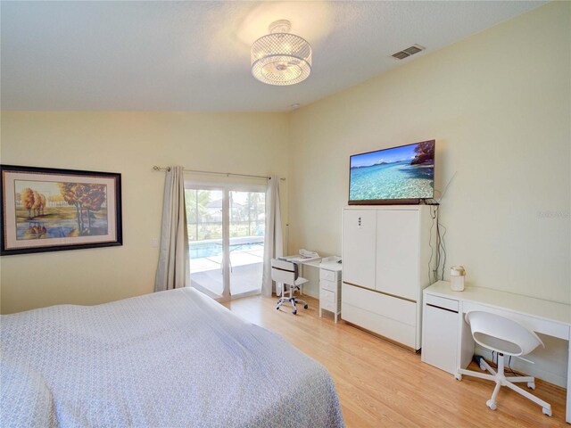 456 Old Bridge Cir, Davenport, FL 33897 - bedroom featuring access to exterior, light wood-type flooring, and a desk