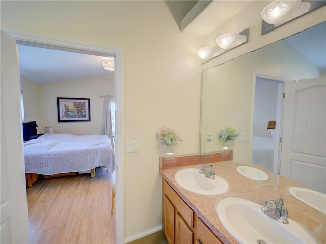 456 Old Bridge Cir, Davenport, FL 33897 - full bath featuring double vanity, wood finished floors, and ensuite bathroom
