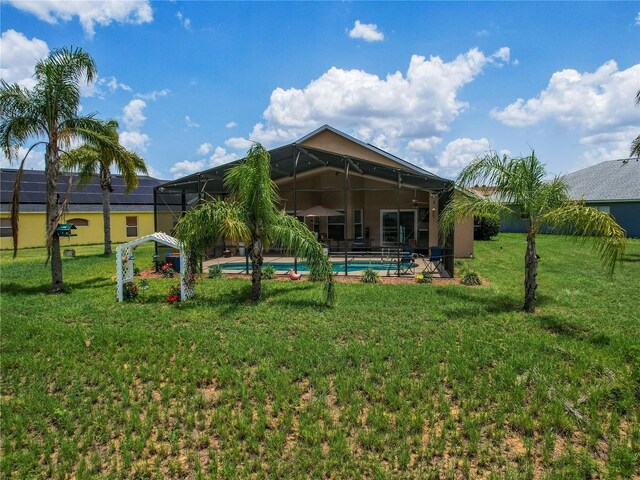 456 Old Bridge Cir, Davenport, FL 33897 - rear view of house featuring an outdoor pool, a lawn, and a lanai