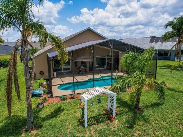 456 Old Bridge Cir, Davenport, FL 33897 - back of property with stucco siding, a lawn, a patio, and an outdoor pool