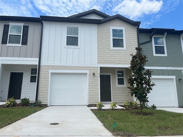 497 Madison Dr, Davenport, FL 33837 - townhome / multi-family property featuring board and batten siding, a garage, and driveway