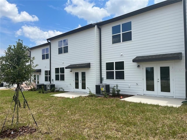 497 Madison Dr, Davenport, FL 33837 - rear view of house featuring french doors, central air condition unit, a yard, and a patio