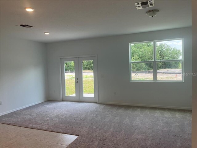 497 Madison Dr, Davenport, FL 33837 - empty room with french doors, carpet flooring, and baseboards