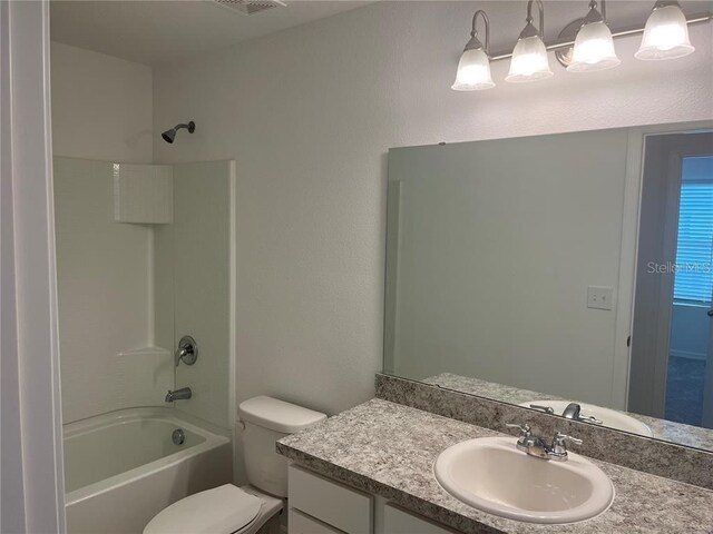 497 Madison Dr, Davenport, FL 33837 - full bathroom featuring vanity, toilet, and  shower combination