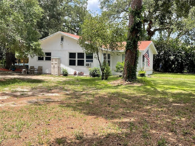 578 3rd St, Daytona Beach, FL 32117 - rear view of property with a yard and cooling unit
