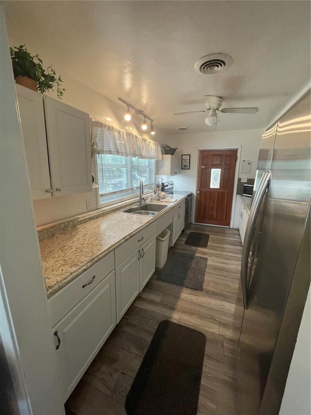 578 3rd St, Daytona Beach, FL 32117 - kitchen featuring freestanding refrigerator, white cabinets, track lighting, dark wood-style floors, and ceiling fan