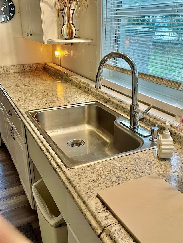 578 3rd St, Daytona Beach, FL 32117 - kitchen view of white cabinets, light countertops, and dark wood-style floors