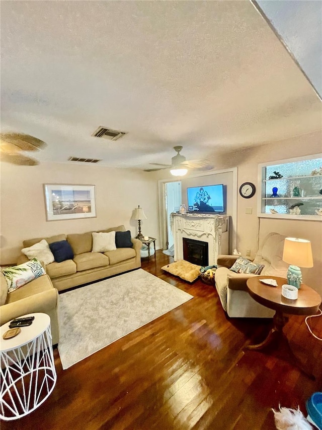 578 3rd St, Daytona Beach, FL 32117 - living area featuring a ceiling fan, wood finished floors, a textured ceiling, and a fireplace