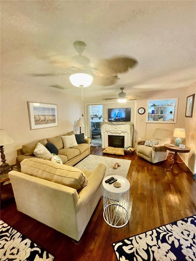 578 3rd St, Daytona Beach, FL 32117 - living area with a textured ceiling, ceiling fan, wood finished floors, a fireplace, and plenty of natural light