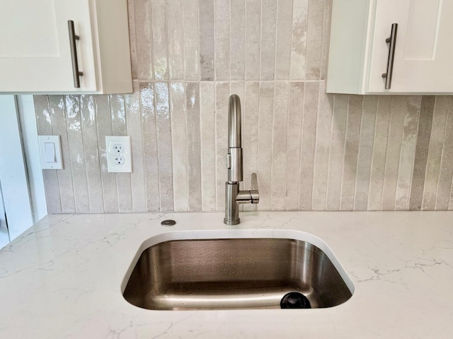 38706 8th Ave, Zephyrhills, FL 33542 - kitchen view of a sink, tasteful backsplash, white cabinets, and light stone countertops