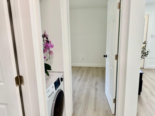 38706 8th Ave, Zephyrhills, FL 33542 - laundry area with washer / clothes dryer, light wood-style floors, and baseboards