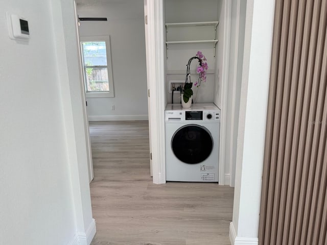 38706 8th Ave, Zephyrhills, FL 33542 - laundry area featuring washer / clothes dryer, light wood-type flooring, and baseboards