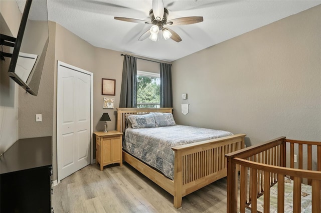 1125 Lake Shadow Cir Unit 5109, Maitland, FL 32751 - bedroom with light wood-type flooring, a textured wall, and a ceiling fan