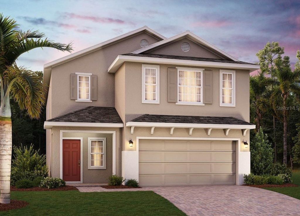 14467 Crestavista Ave, Clermont, FL 34714 - view of front of property with a garage, decorative driveway, a front yard, and stucco siding